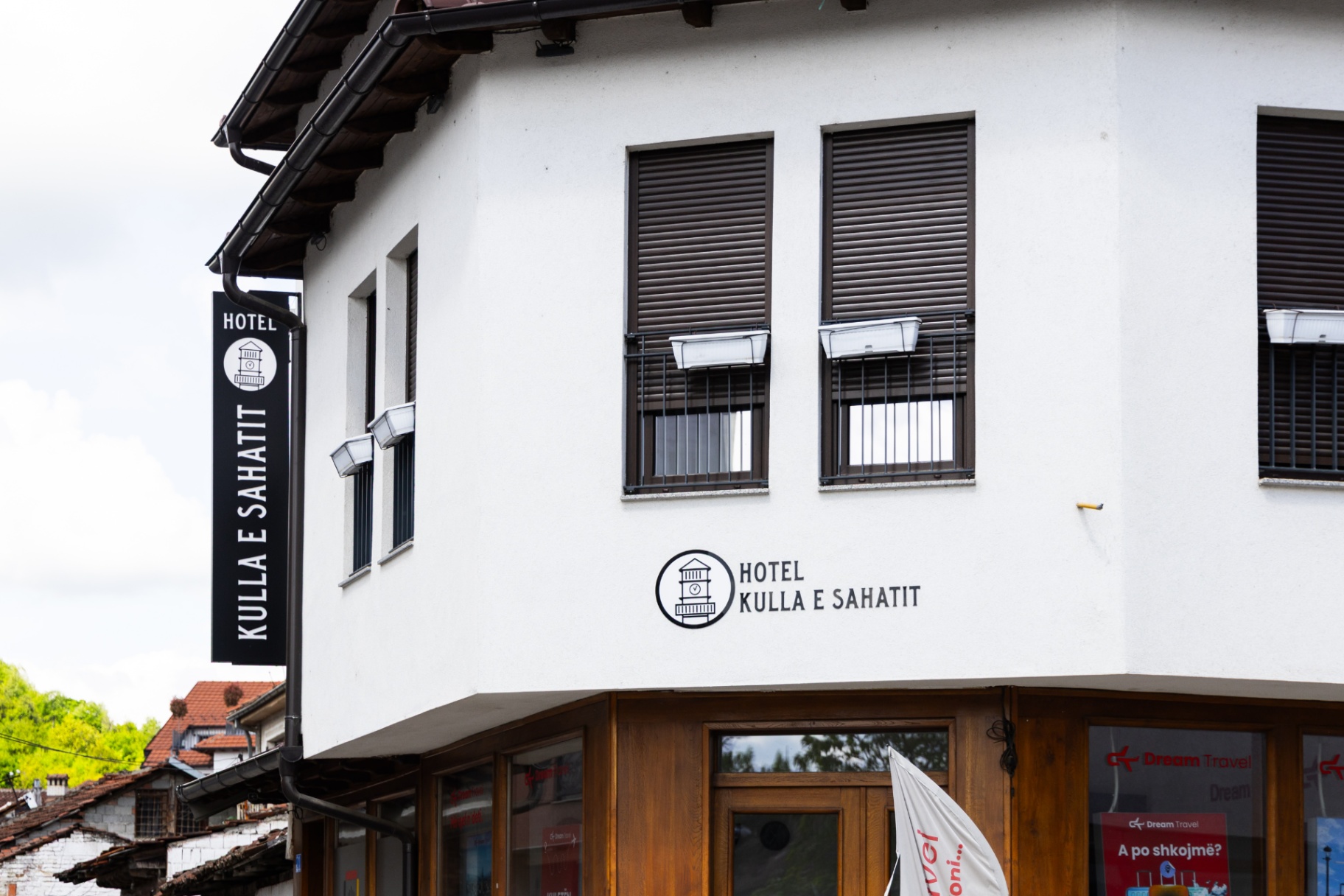 Detail of the Hotel Kulla e Sahatit corner signage and windows